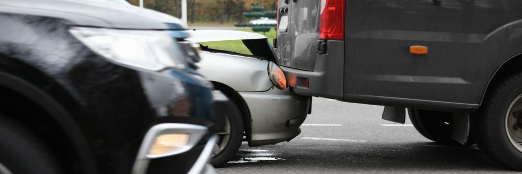 Car and blue minivan crash on road closeup. Road traffic accidents concept