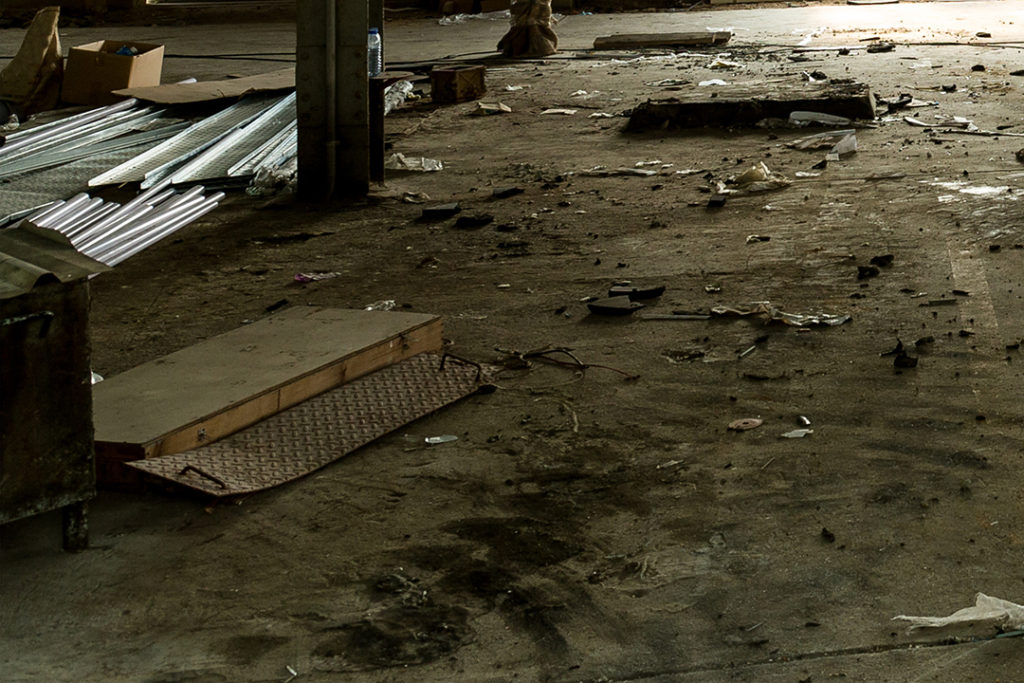 Damaged and obstructed floor of warehouse, workplce