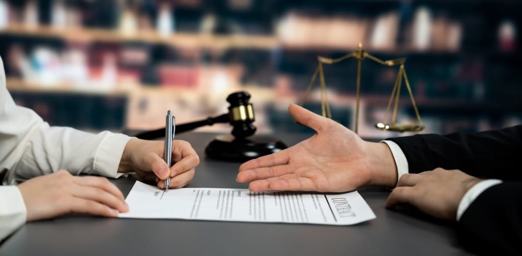lawyers signing contract in law firm
